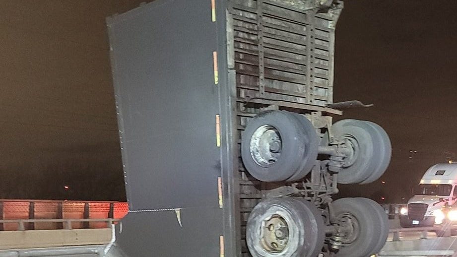 Driver defies death in semi-truck crash; truck dangling between Indiana Toll Road bridges