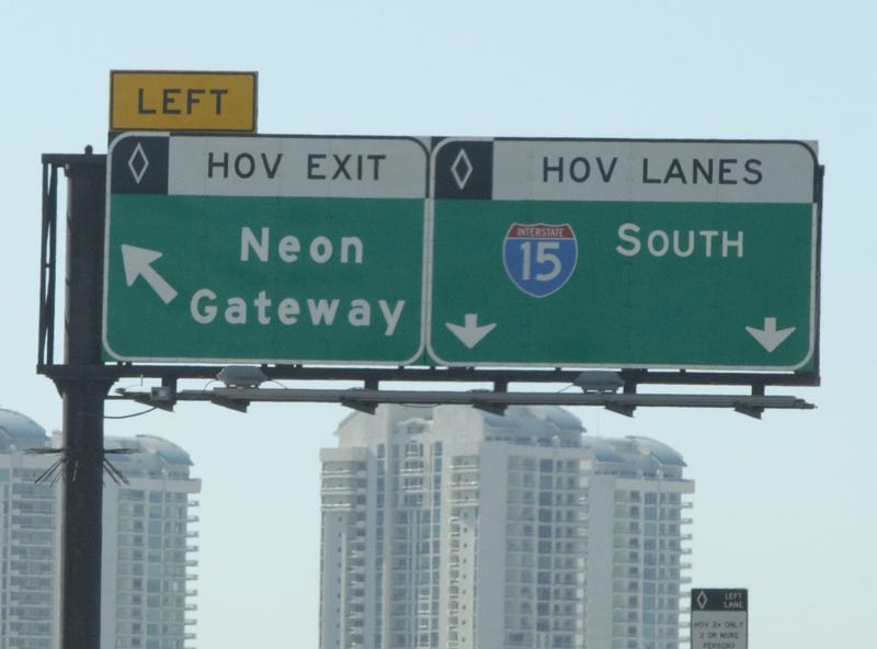 Overhead freeway signs direct drivers to HOV lanes