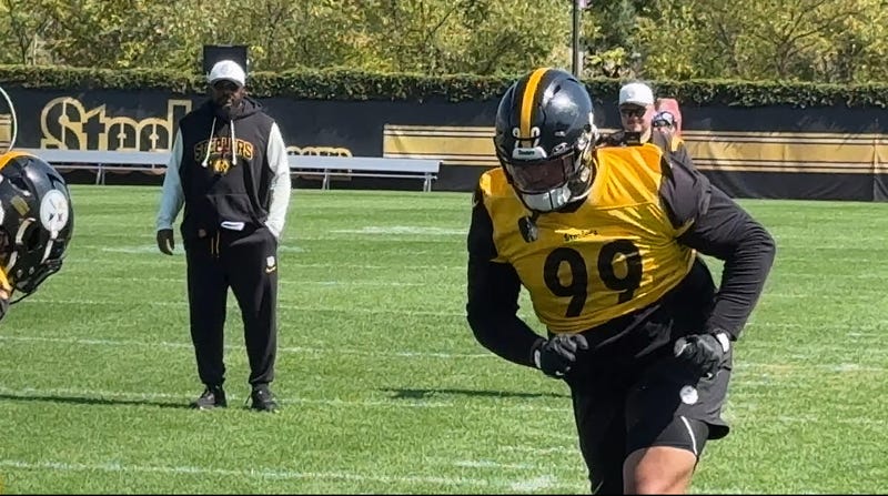 Derrick Harmon with Mike Tomlin in the background