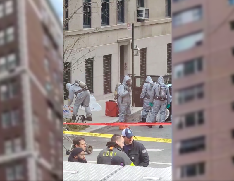 Crews in hazmat suits probed the Jeep after a woman was found dead of a suspected suicide with toxic chemicals inside .