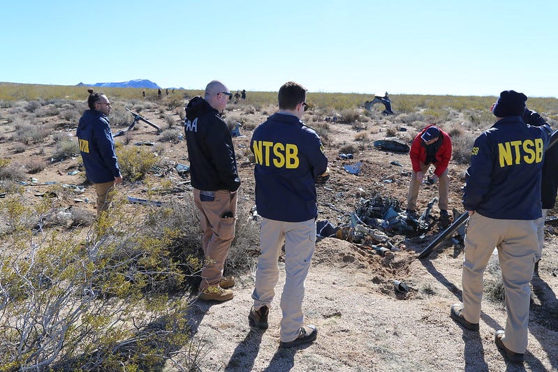 Representatives from the NTSB examine wreckage from a helicopter crash near the California-Nevada border