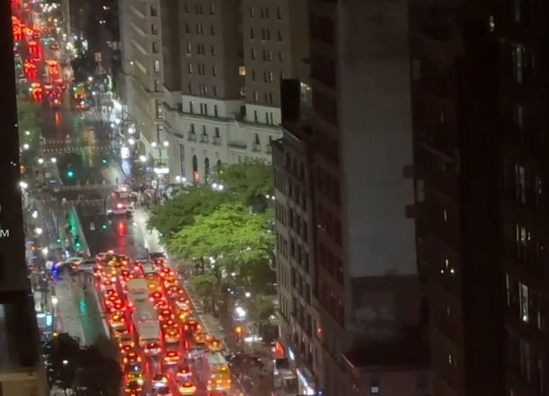 Citizen App footage from above the scene shows traffic halted as police respond to a moped crash that hospitalized the driver and two pedestrians.