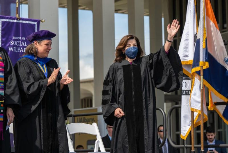 Hochul waves to the crowd at the SUNY Albany graduation ceremony.