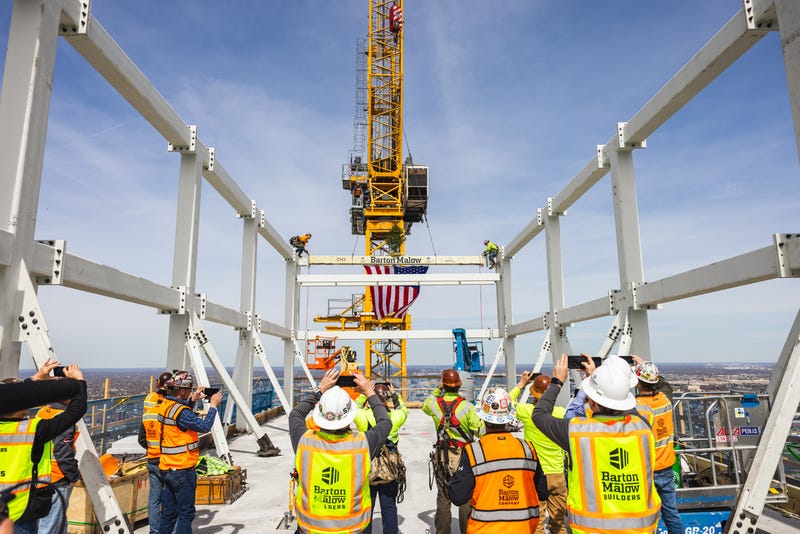 Construction workers take photo of final beam installment at Hudson's site tower