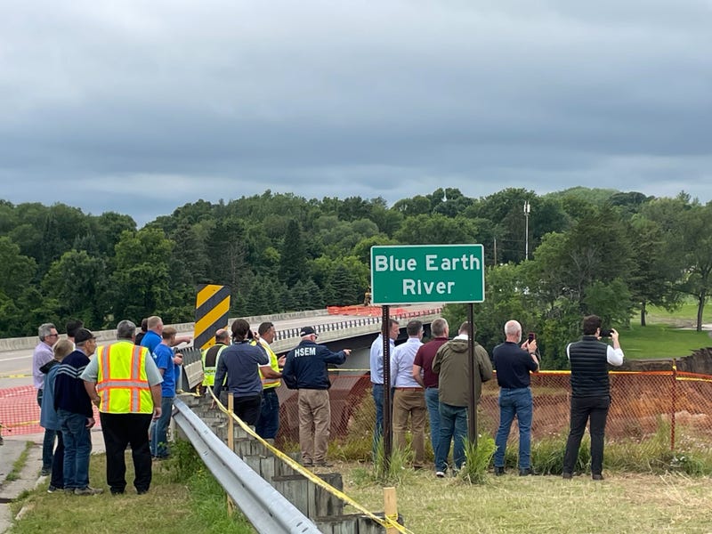Officials including Governor Tim Walz examine the flooding damage on the Blue Earth River in southern Minnesota Tuesday.
