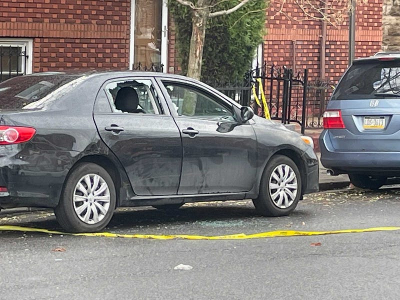 The family's Toyota Corolla with multiple shattered windows remained at the crime scene Friday morning