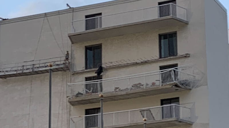 A balcony collapsed at a Seal Isle City condominium building on Friday, trapping a worker beneath.