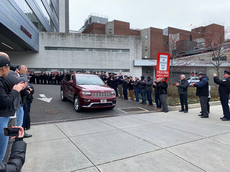 PPD applauding an officer as he's discharged from the hospital