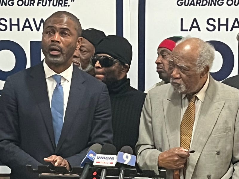 Rep. Danny Davis (D-7th District), right, listens as state Rep. LaShawn Ford talks to reporters on Chicago's West side. 