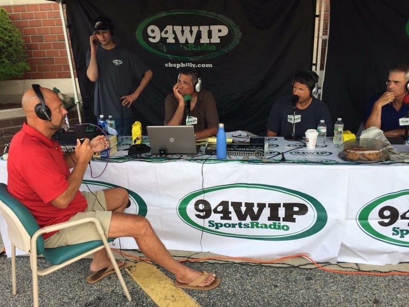 Angelo Cataldi talking with former Phillies star Darren Daulton during a live remote broadcast.