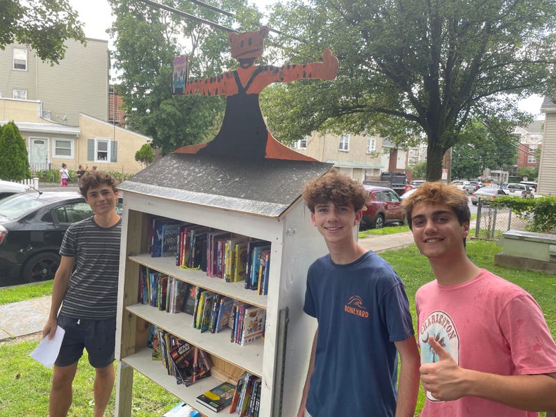 Students Luca Giobbio, Eli Tannenbaum and Griffin McIntyre with their community book depot