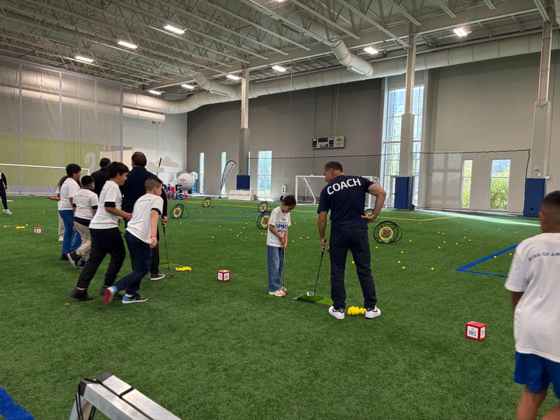Nine-year-old Natalie Ascencio practices her golf skills at Bank of America's Sports with Us clinic. A hundred students participated in the clinic at the ComEd Recreation Center in Pilsen.