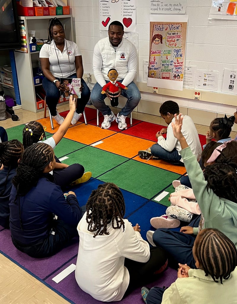 Their first joint book reading to second graders at John T. Pirie Fine Arts and Academic Center on the Southside was a hit with students, teachers and faculty.  The featured book was "Hair Love" by Matthew A. Cherry.