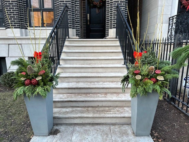 holiday planters at the bottom of house steps