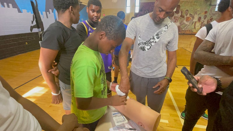 Children at Christy Rec Center learning how to halt bleeding from gunshot wounds.