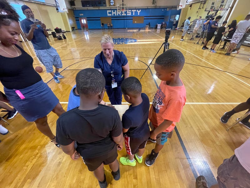 Penn Medicine professionals teaching young kids how to stop a gunshot victim from bleeding.