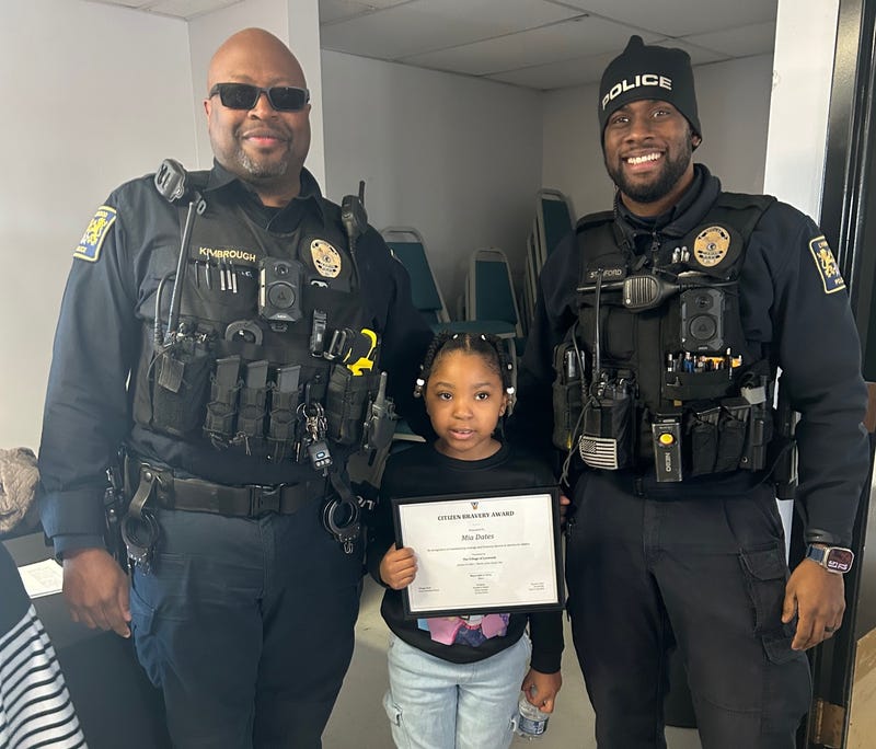 Mia Dates, 7, is honored for her bravery by the Lynwood Police Department