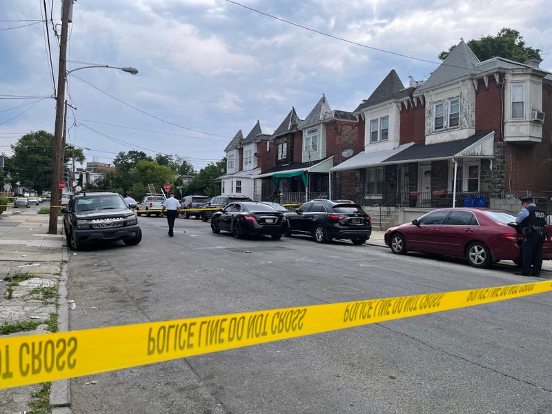Police on the scene of a triple shooting in the city's Overbrook section. Two men were killed, and a three-year-old boy wounded.