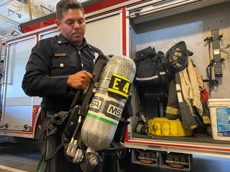 Oakland Fire Department Lt. Nathan Leal shows off one of the department's new self-contained breathing apparatuses.