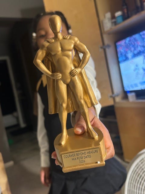 Mia Dates shows off her bravery award