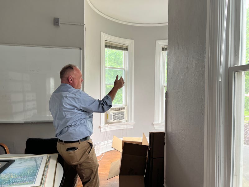 Edwardsville School Superintendent, Dr. Patrick Shelton stands in one of the rooms of the Hadley House featuring a turret and curved windows.