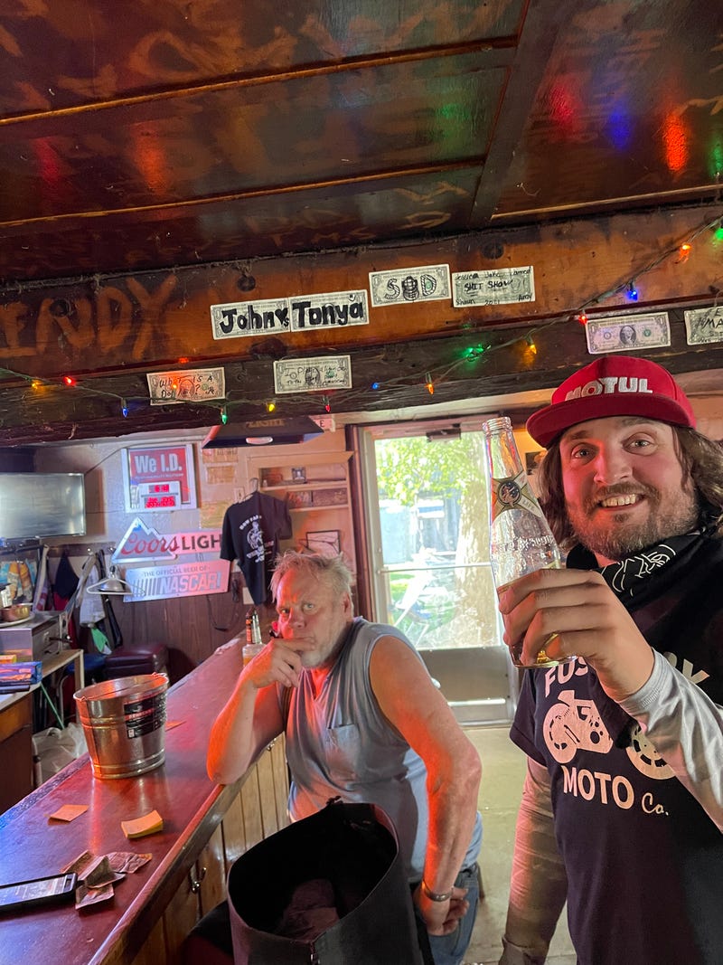 two guys in a dive bar that looks like a dump