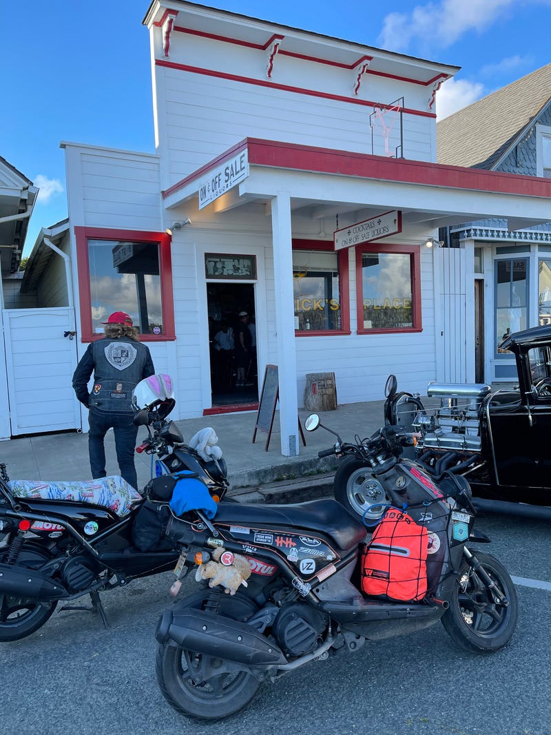 scooters outside some dumpy dive bar