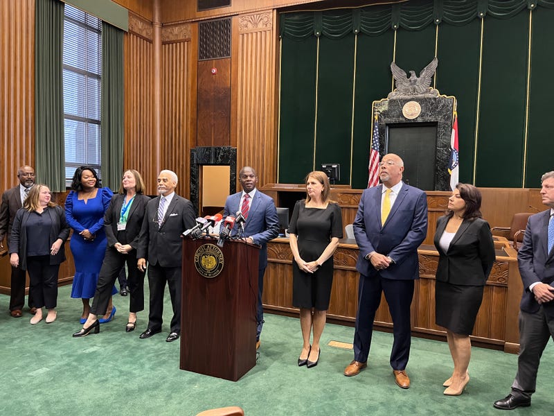 Circuit Attorney Gabe Gore, flanked by his office's leadership, addresses his first year in office