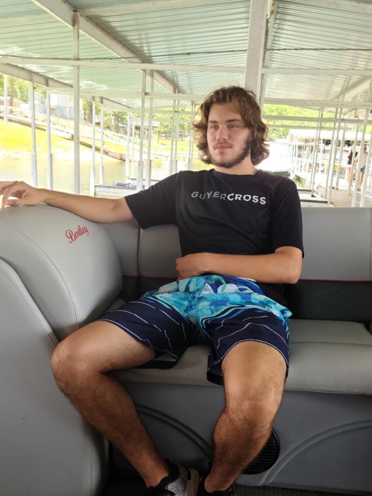 Dylan Dorrell relaxes in a Cross Country t-shirt. His family says running gave Dylan peace of mind.