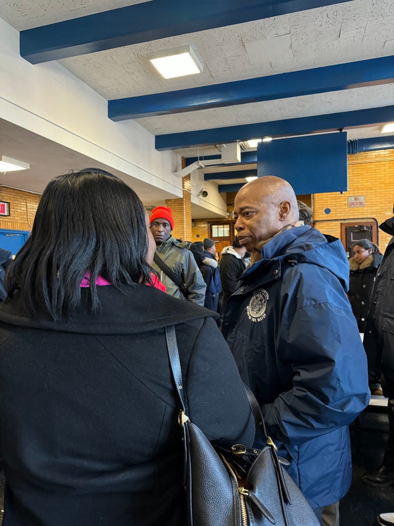 Mayor Eric Adams speaks with displaced residents at P.S. 76, where a temporary shelter was set up on Jan. 10, 2025.