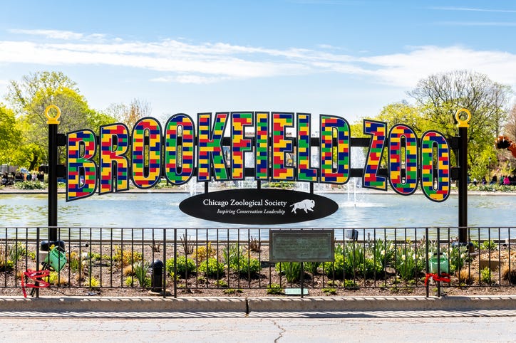 Brookfield, IL, USA - May 3, 2019: Brookfield Zoo sign in front of their Roosevelt Fountain. The zoo is home to over 2300 animals and over 450 different species.