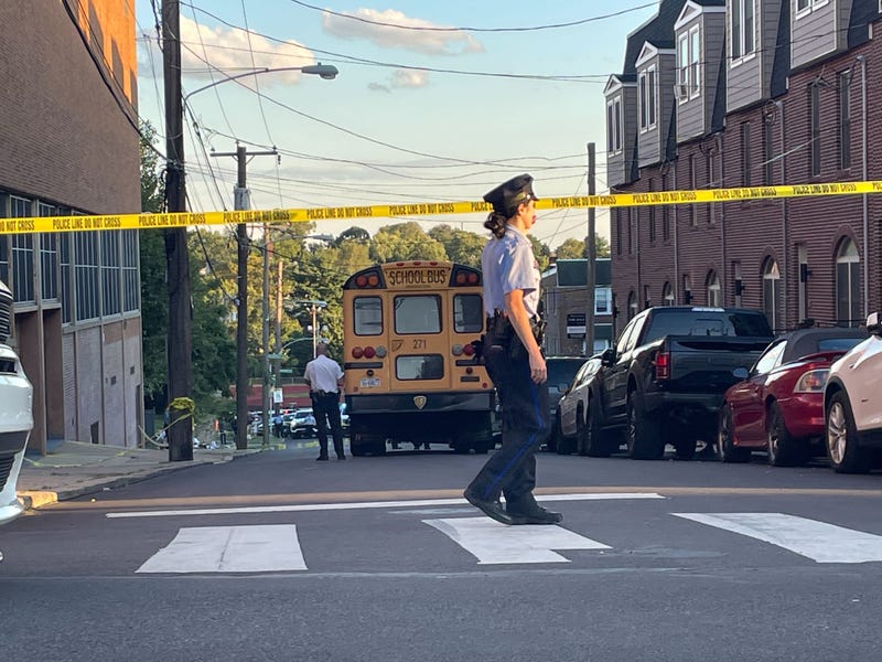 A police officer helps block off the road near the shooting at Roxborough High School on Sept. 27, 2022.