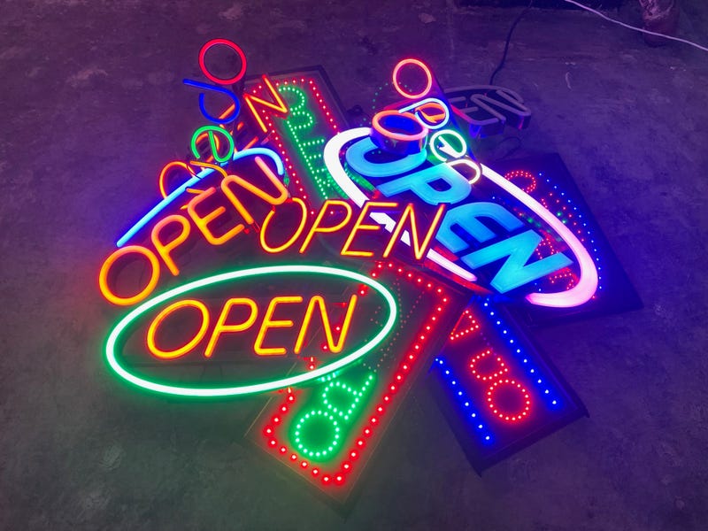 A pile of "open" neon signs at the Neon and Light Museum