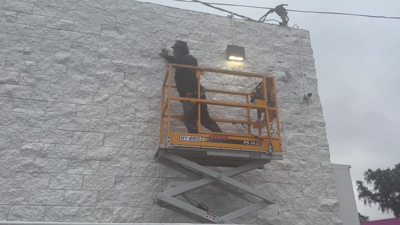 Robert Vargas prepares to paint the mural