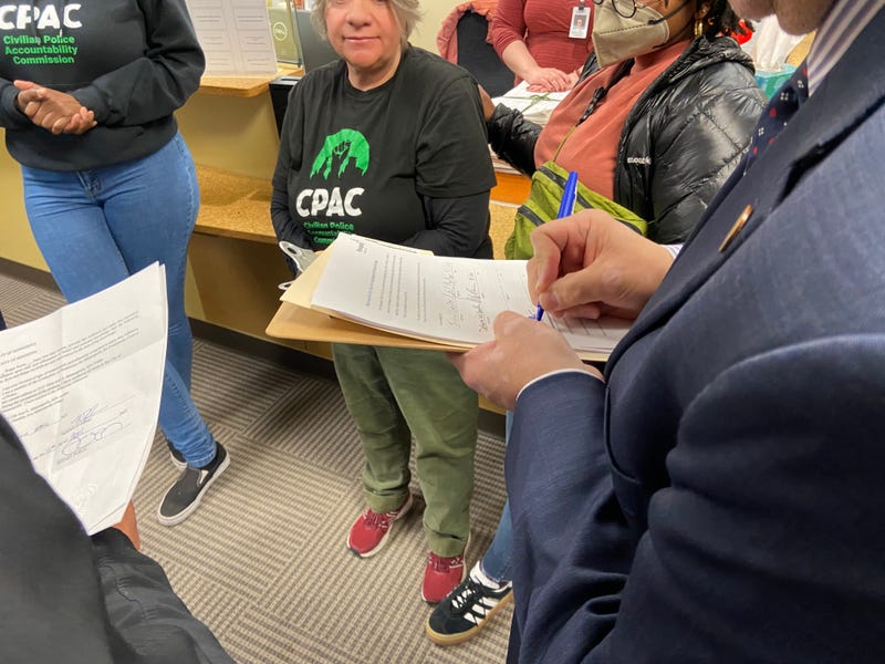 Citizens signing CPAC's petition to the city clerk.