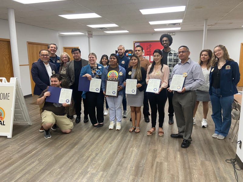 Immigrants from Ecuador proudly show off the new resolution supporting temporary protection status as they flee the violence, political persecution and economic and social disasters in their country.