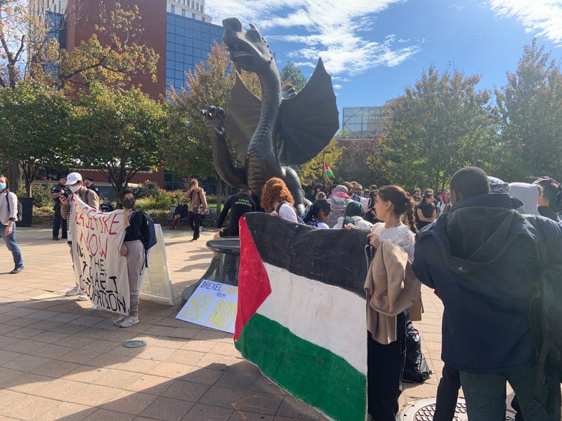 Students from Penn and Drexel on Wednesday started their demonstration at Drexel's dragon statue before walking a half-mile to Penn's campus.