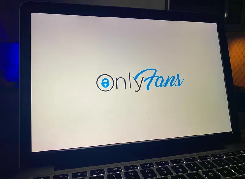The OnlyFans website loading on a laptop. 