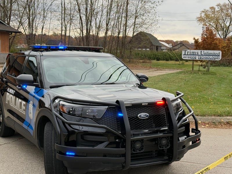 Police parked outside the shooting scene at Trims Unlimited. 