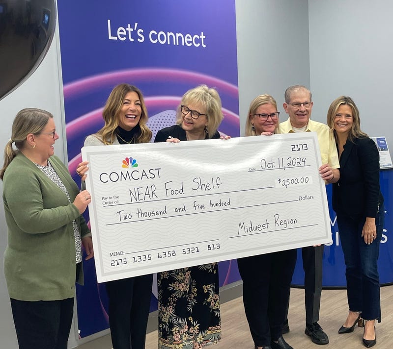 Comcast donates to NEAR Food Shelf at Xfinity store opening in Crystal, Minnesota.