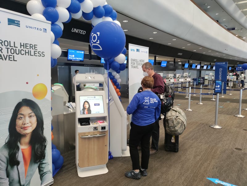 A passenger uses new facial recognition technology to check in at SFO.
