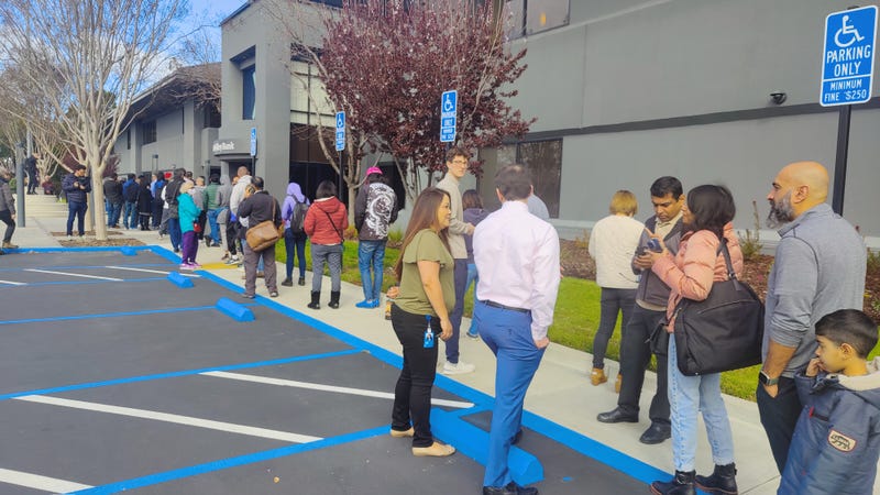 People are lined up outside the bank Monday morning.