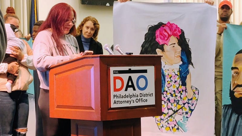 Laura Ortiz (at podium) shares memories of her slain 15-year-old daughter, memorialized by artist Russell Craig for the District Attorney's Office and Mural Arts Philadelphia.