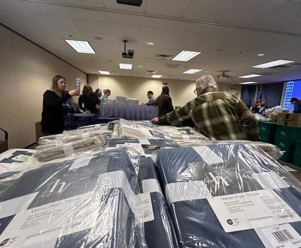 Bremer Bank employee volunteers worked like an assembly line, packing a total of 750 boxes, each filled with essentials like plates, silverware, cleaning supplies, blankets and towels all beneath a note that read, “We hope these items are useful as you settle in. Welcome home!”