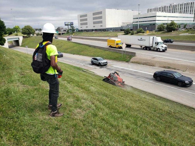 Operating a remote-controlled lawnmower in Detroit. 