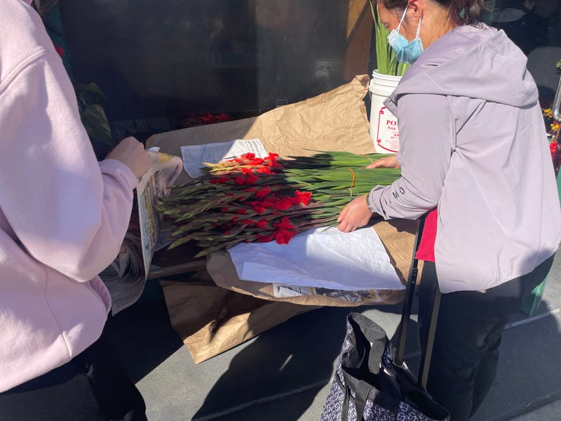 Angela Chin's family helping customers purchase Chinese New Year flowers.
