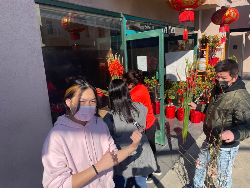 Angela Chin's and her mom helping customers purchase Chinese New Year flowers.