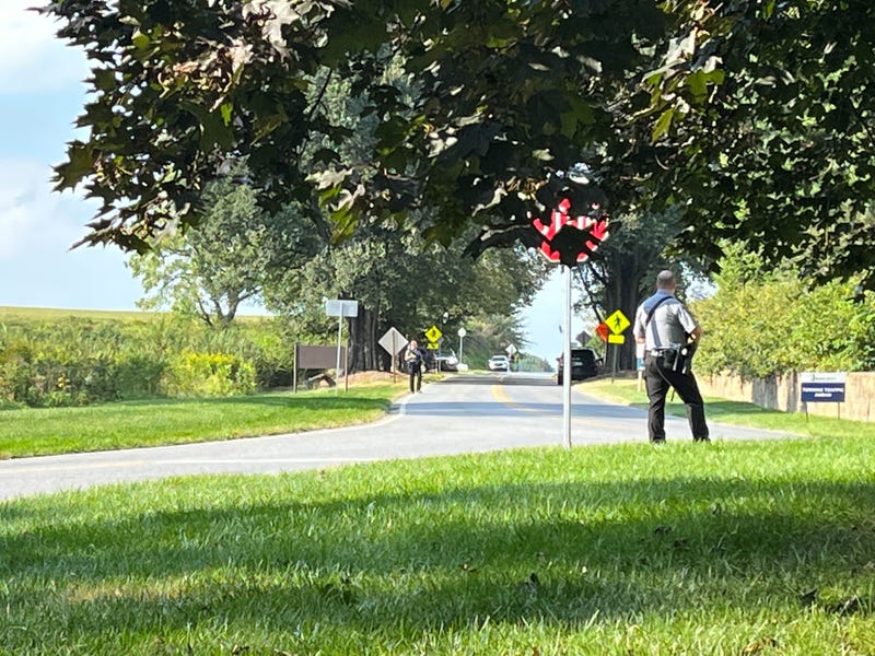 Officers looking down Conservatory Road from Longwood Road in Chester County during the search for Danelo Cavalcante.