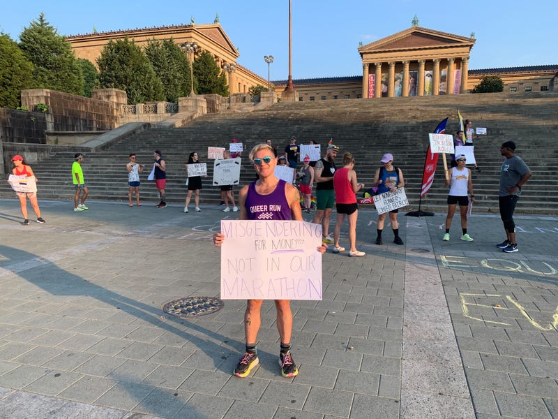 On Saturday, as Philadelphia Marathon organizers kicked off training season for November's 26.2-mile race throughout the city, more than two dozen demonstrators stood on the Art Museum steps calling for a separate category with equal prize money.