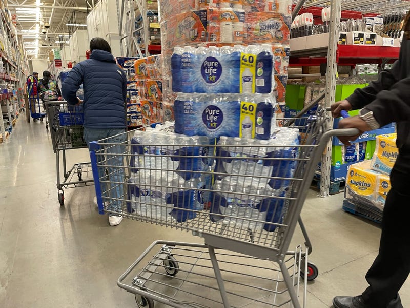 A long line of customers stretched across half of the Deptford, N.J., Sam’s Club, all trying to take home bottled water.